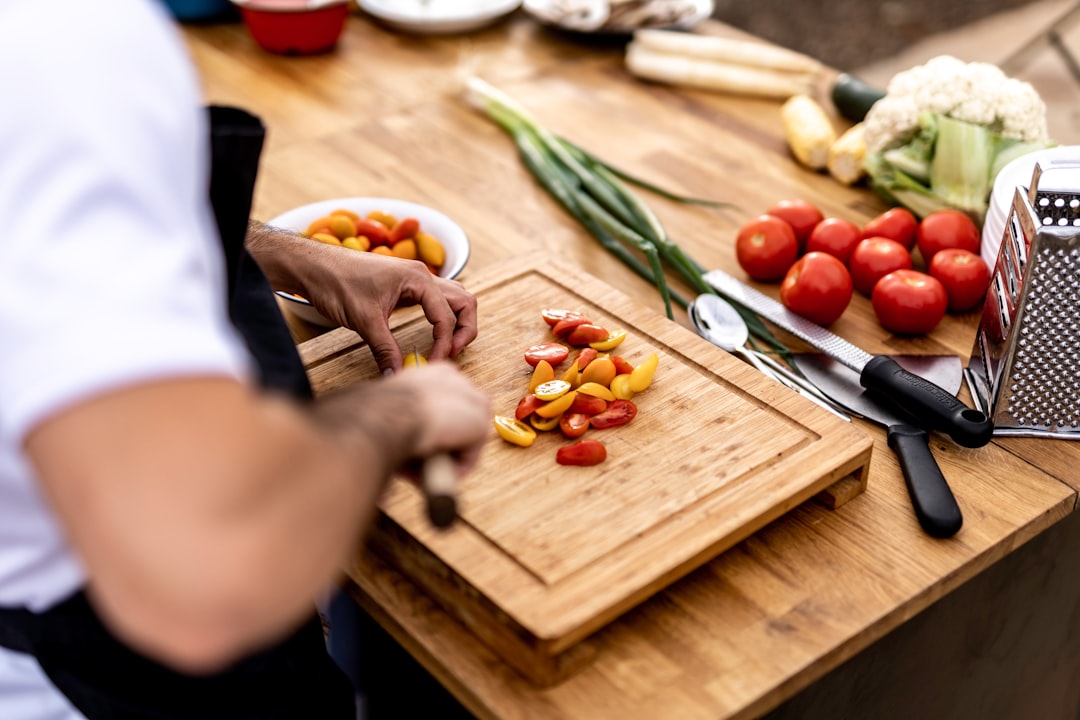 a-person-cutting-up-vegetables-on-a-cutting-board-s2eql9vhn3o