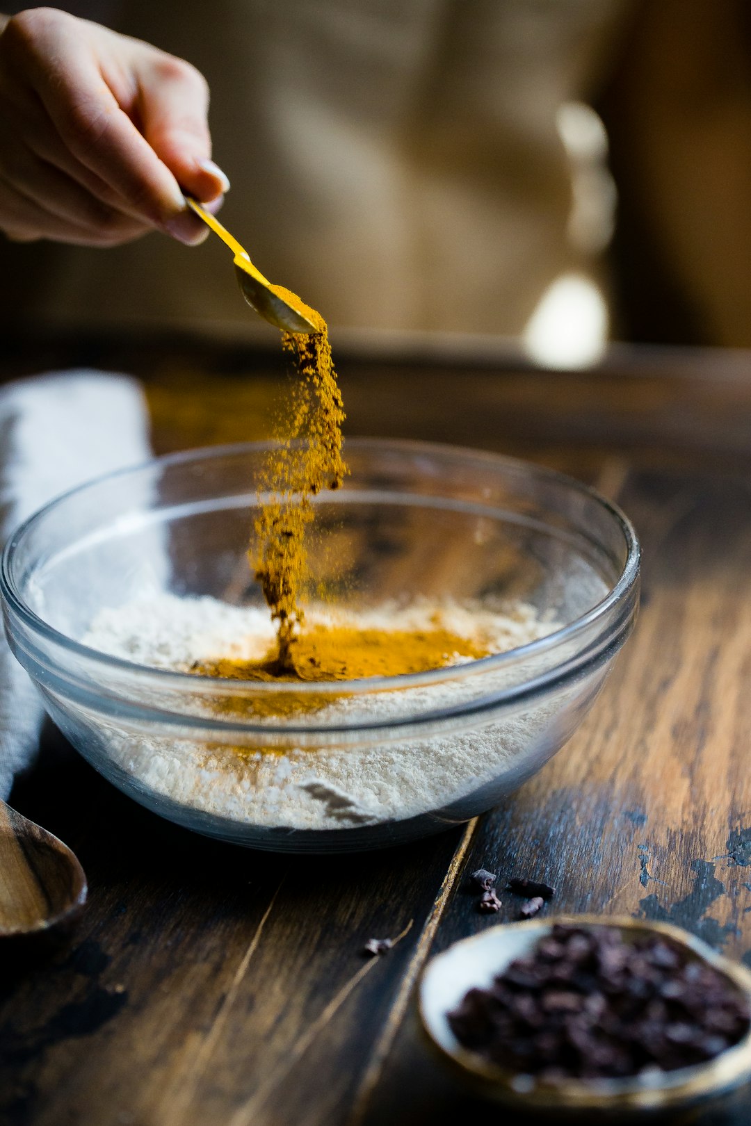 I took this photo with a small light source and a super fast shutter speed. I love this photo because it makes me feel happy. I love to bake, which is what’s obviously happening. Plus the bright turmeric is a happy color.